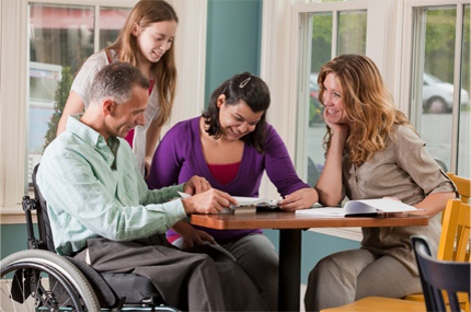 Veteran in wheelchair, with his family