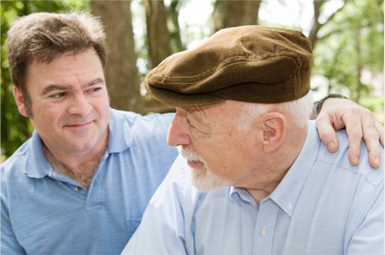 Son putting his arm around his veteran father.